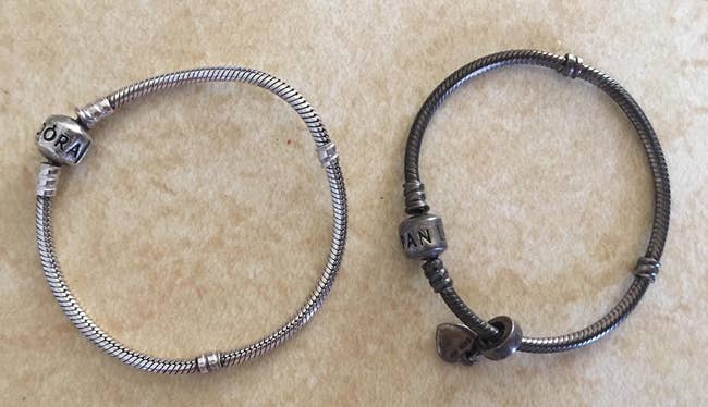 reviewer's two bracelets, one tarnished before being clean and the other clean, and silver after using wipes