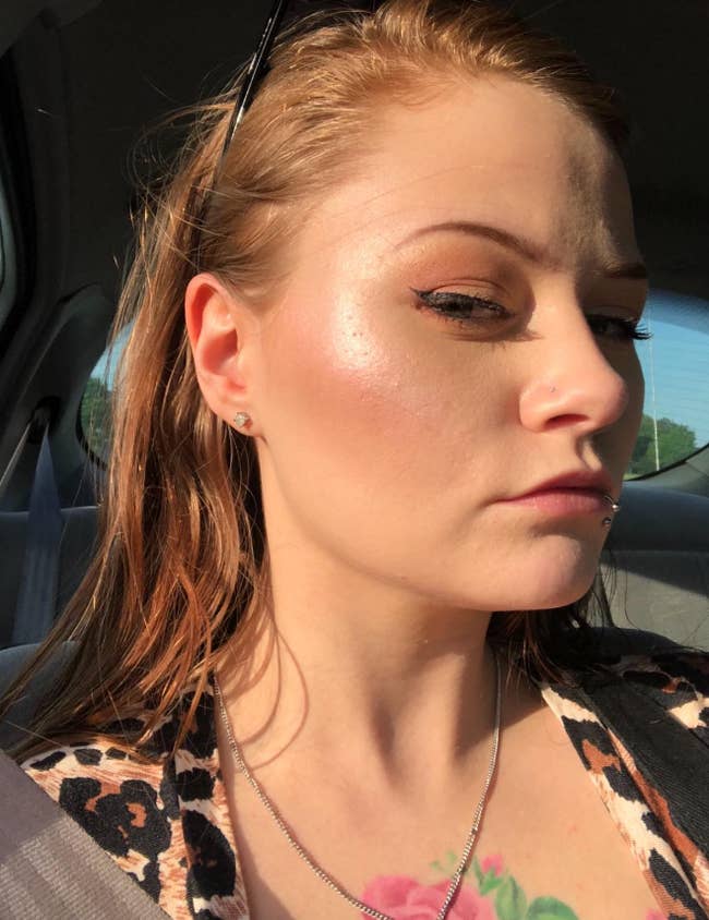 reviewer in the car taking a selfie wearing highlighter