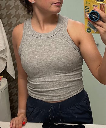 Image of reviewer wearing gray tank top