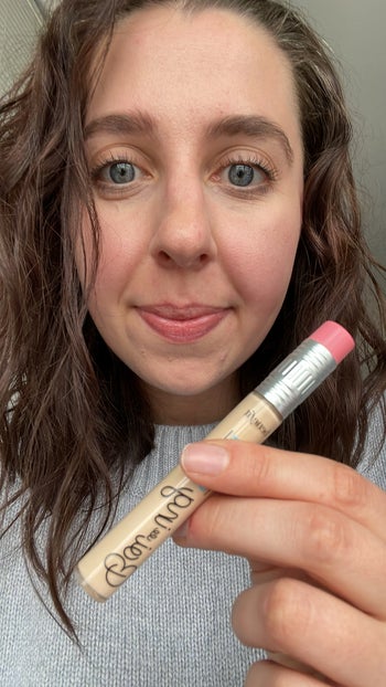 buzzfeed editor holding concealer that looks like a number 2 pencil