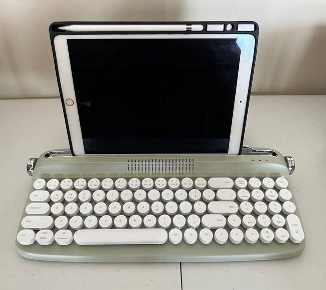 the mint-colored keyboard with an iPad in its stand holder