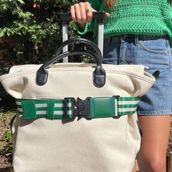 a green-and-white striped belt on a bag