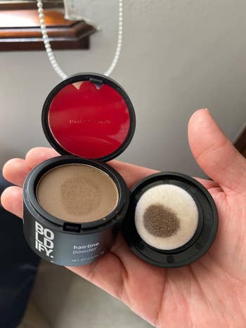 reviewer holds open Bodify hairline powder container with sponge applicator