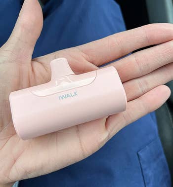 reviewer holding the pink charger in their hand for scale