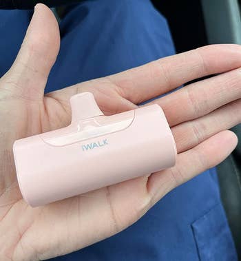 reviewer holding the pink charger in their hand for scale