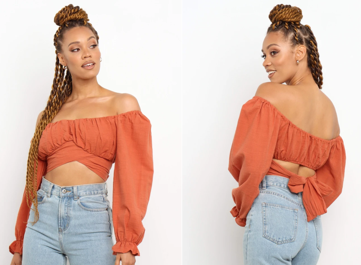 model wearing the off-the-shoulder balloon-sleeve crop top in orange