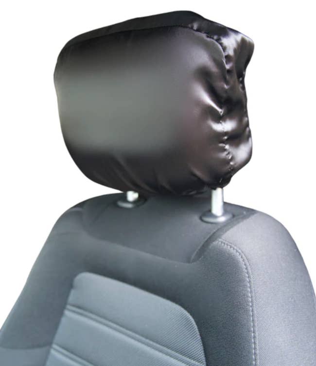 a black satin headrest cover on a car headrest