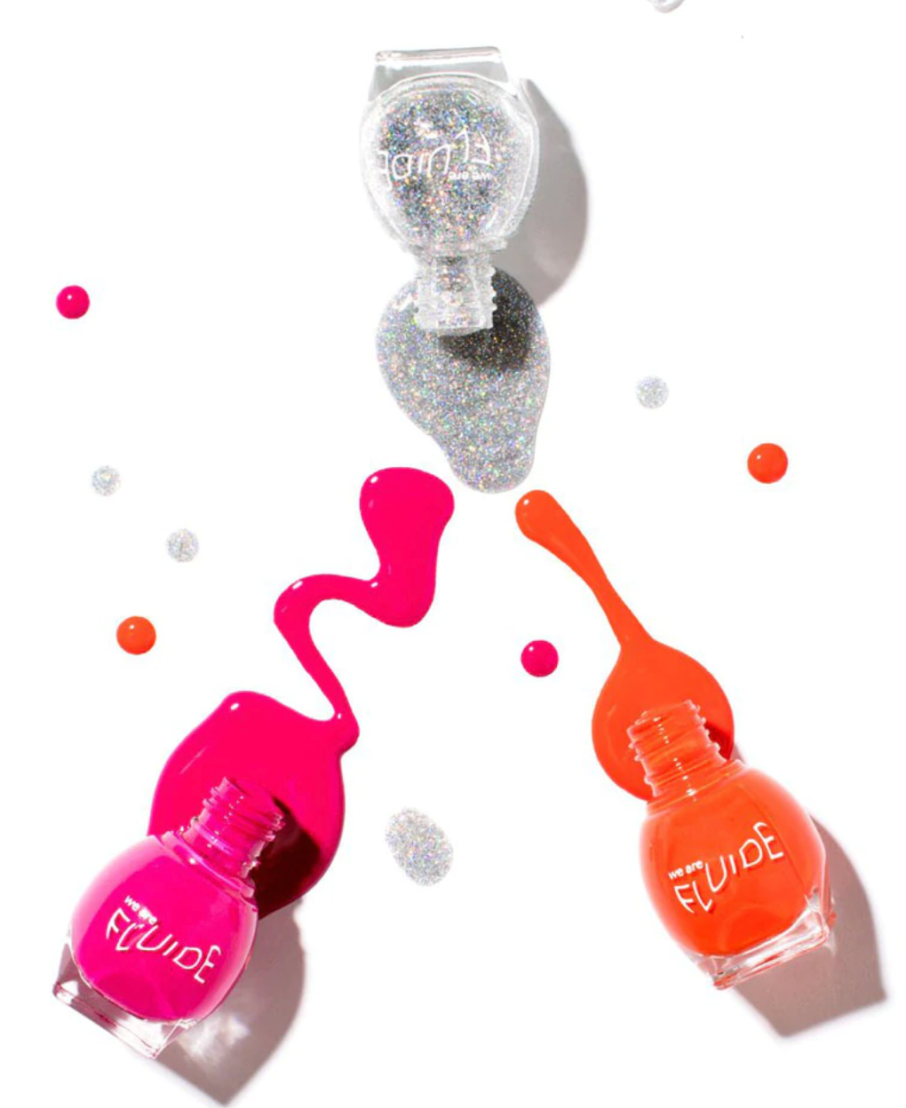 bottles of pink, orange, and silver glitter nail polish