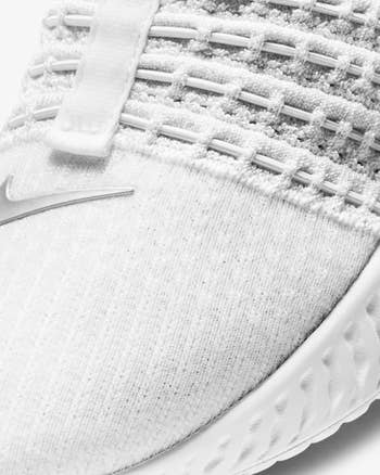 A close-up of the elastic stings weaved through the knit material on the top of the sneaker
