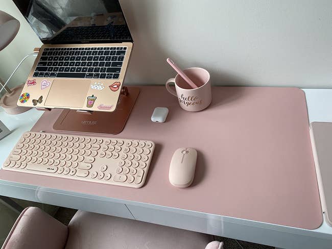reviewer's desk with the pink desk mat on it