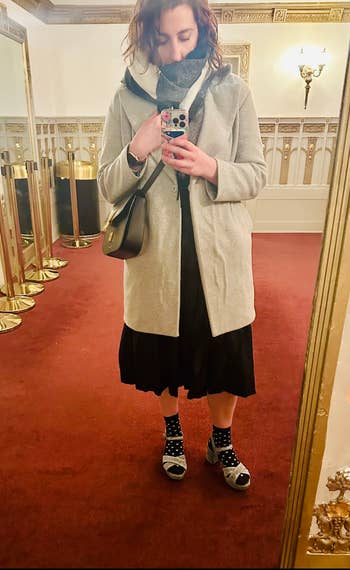 writer wearing the heels with socks and a skirt