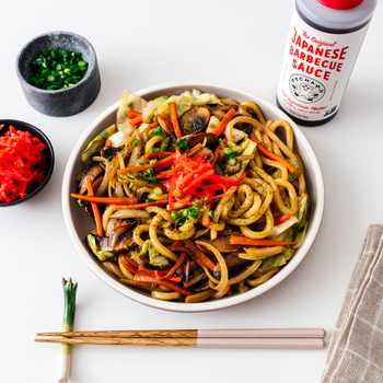 the sauce next to a plate of noodles