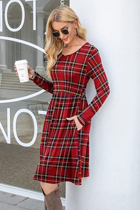 Model is wearing a red plaid dress