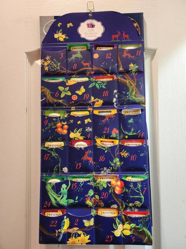 Advent calendar with 24 festive slots, each   numbered, featuring Twinings beverage  bags arsenic  portion  of a vacation  buying  feature