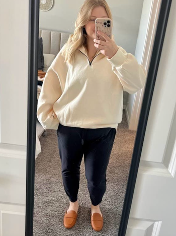 Reviewer in off white half-zippered long sleeve sweater 