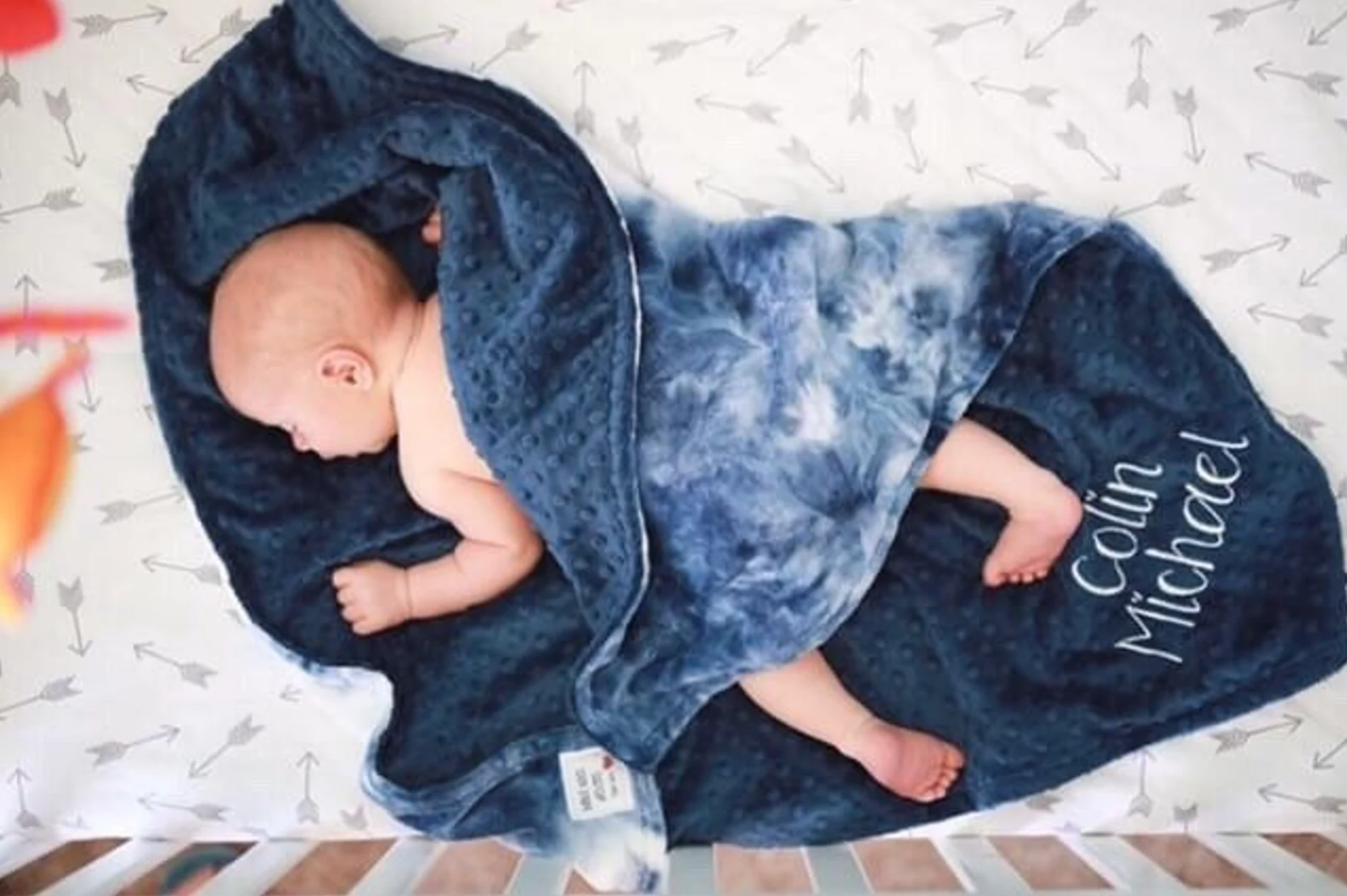 Model wrapped in navy blue and white tie dye blanket with 