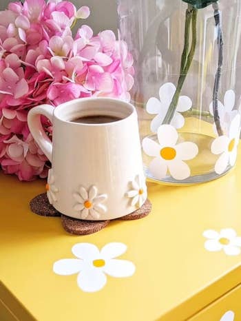 a single white mug on a yellow daisy table