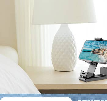 the black phone mount on a nightstand holding a phone