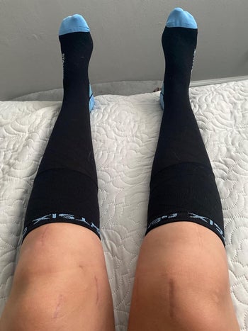 reviewer wearing black compression socks