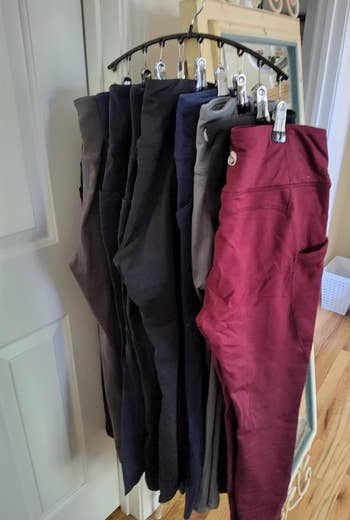 another reviewer photo of 10 pairs of leggings hanging on the organizer