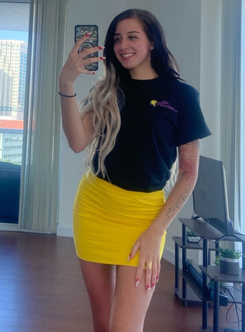 Reviewer wearing yellow mini skirt