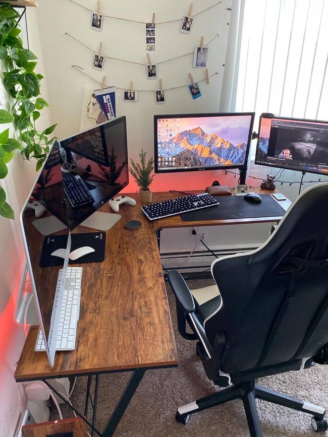 reviewer's L shaped desk set up for gaming with four monitors