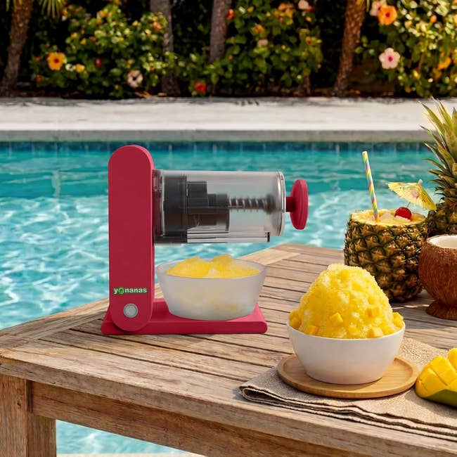 A room  appliance sits by a pool, making a frozen dessert that resembles shaved ice, with caller  pineapple successful  a vessel  beside it