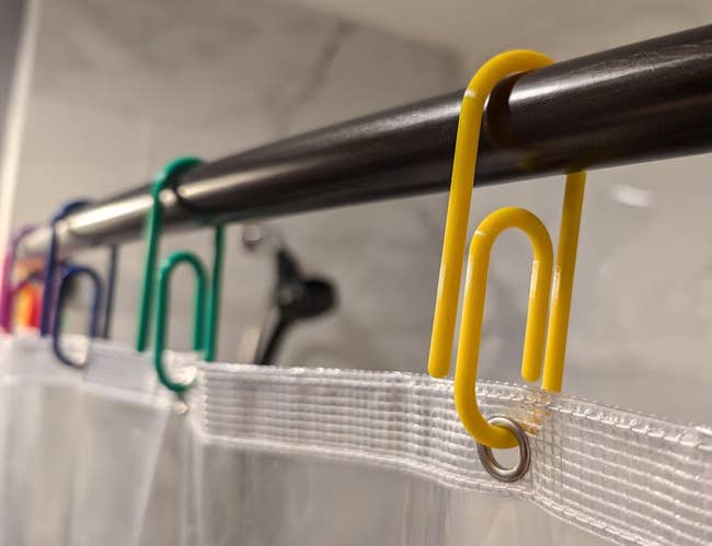 Colorful jumbo paperclips utilized arsenic curtain hooks connected a ablution rod