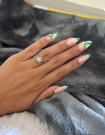 reviewer wearing green squiggle almond-shaped nails