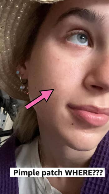 Close-up of a reviewer's face with clear skin and a pink arrow pointing at her cheek. Text at the bottom reads,