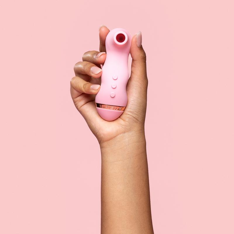 Model holding pink suction vibrator