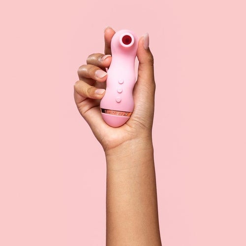 Model holding pink suction vibrator
