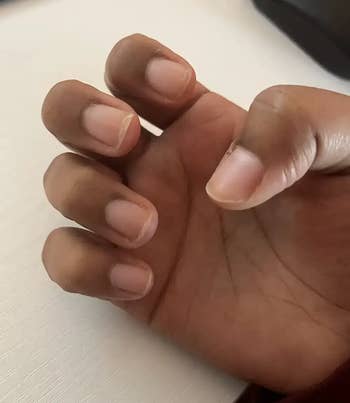 A close-up of a manus  showcasing clean, earthy  nails, suitable for a minimalist manicure benignant   successful  a buying  context