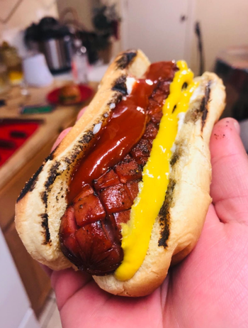 A hot dog in a bun with the cross hatches on it 