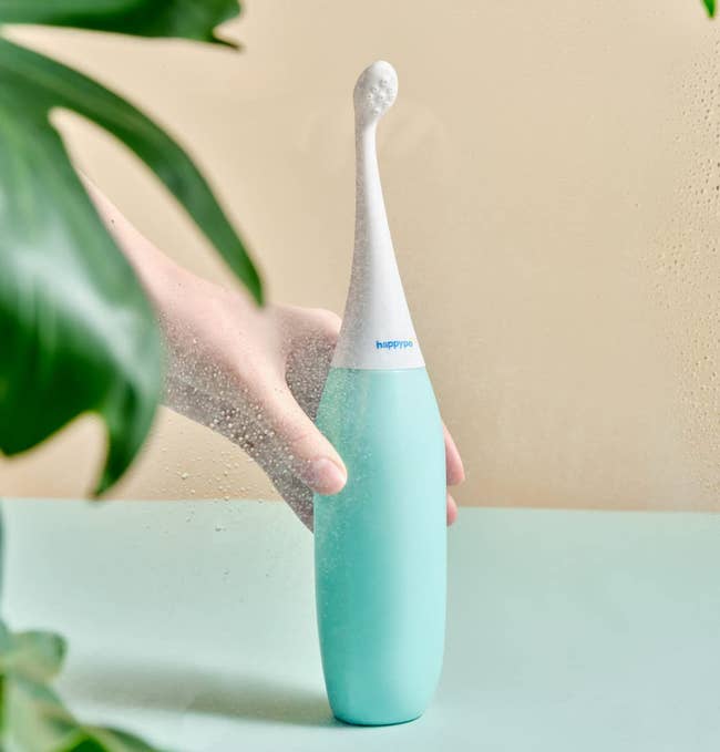 Model holding a Happypo portable bidet