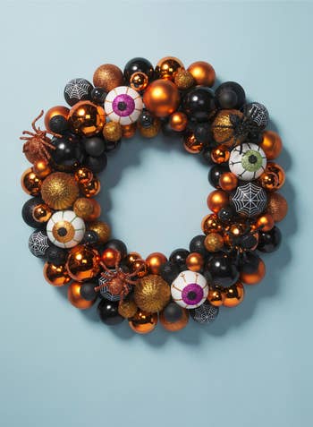 the black and orange halloween wreath with eyeballs, spiders, and ornaments
