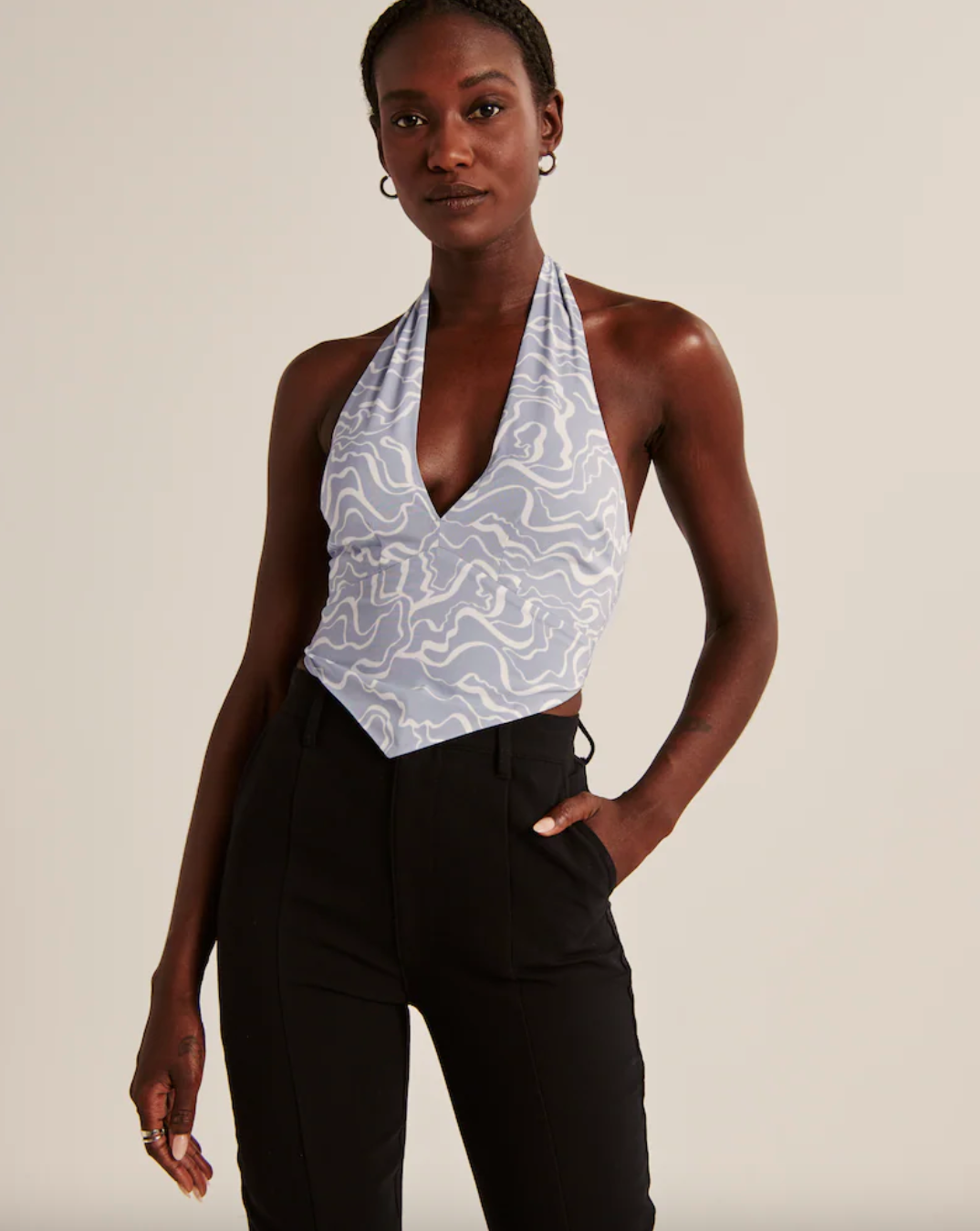 model wearing blue and white pointed hem halter top
