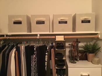reviewer using four cubes on their closet shelf with labels