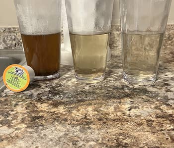 three glass cups showing the water getting clearer after each clean