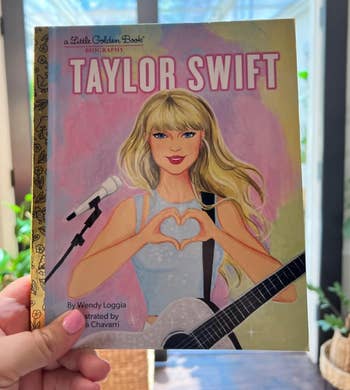 the illustrated cover of taylor swift making a heart sign gesture 