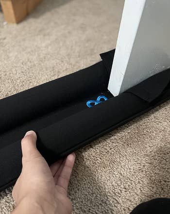 a reviewer installing the door draft stopper 