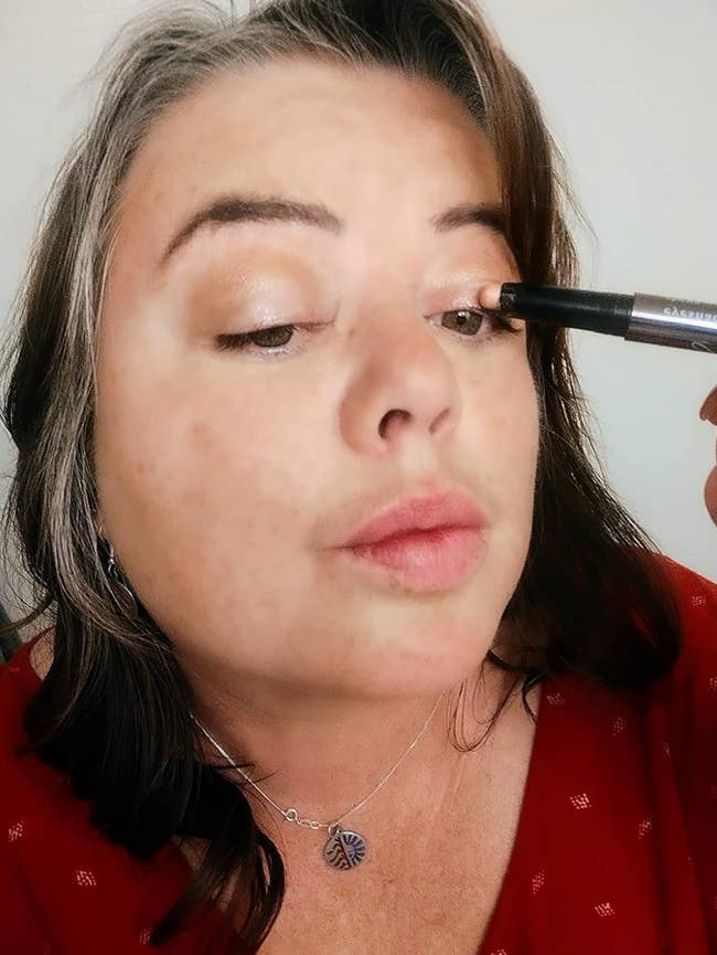reviewer applying eyeshadow using the eyeshadow stick