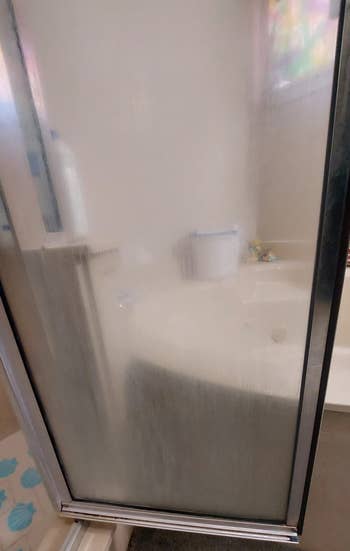 Reviewer photo of dirty glass shower door