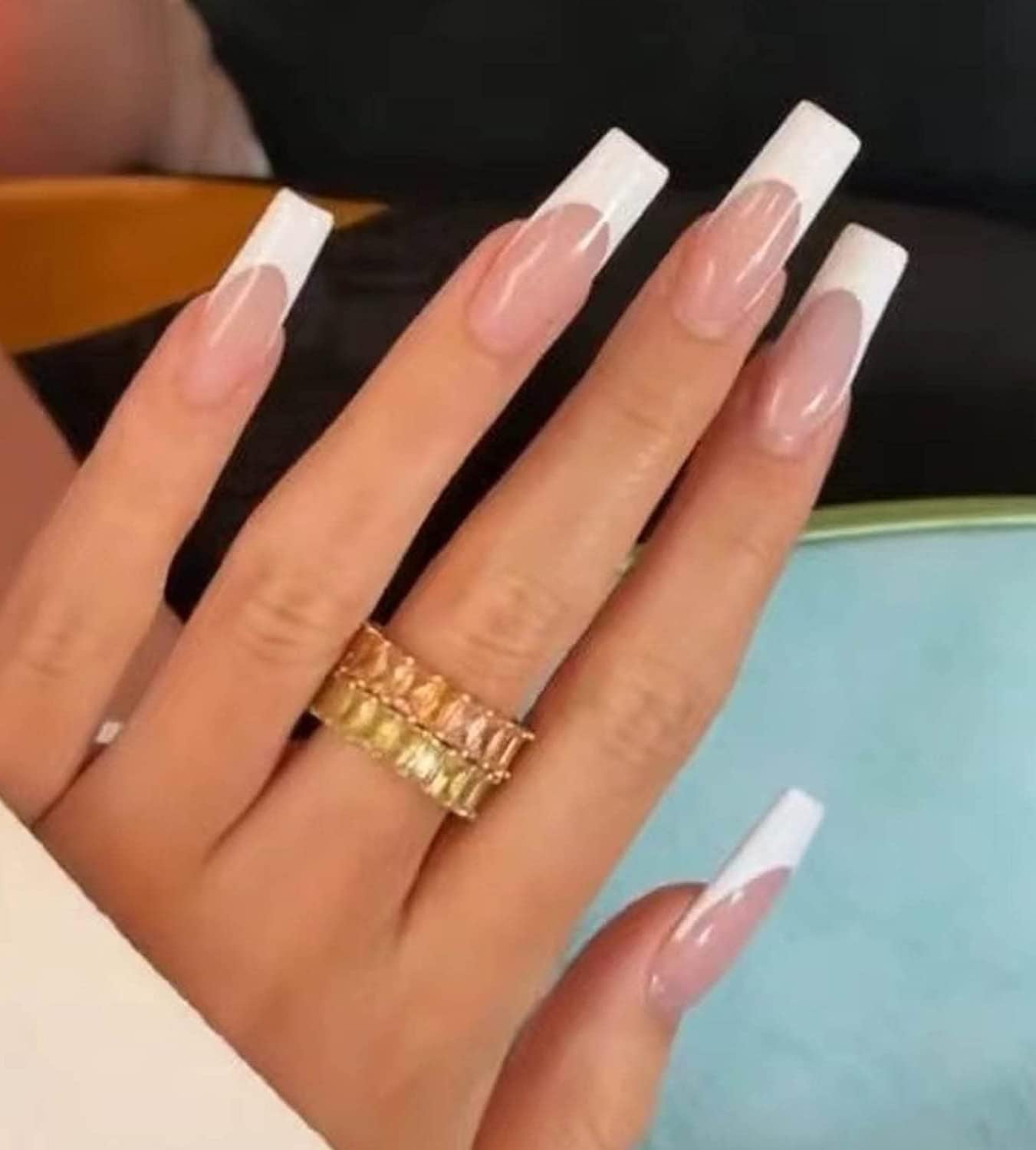 model's hand with long french manicure nails