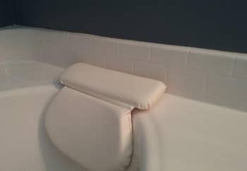 Reviewer's bath pillow suctioned onto their tub