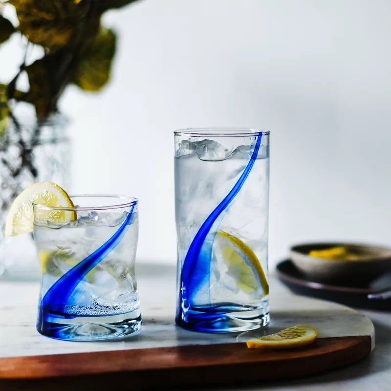 A tall and short glass with a blue ribbon detailing