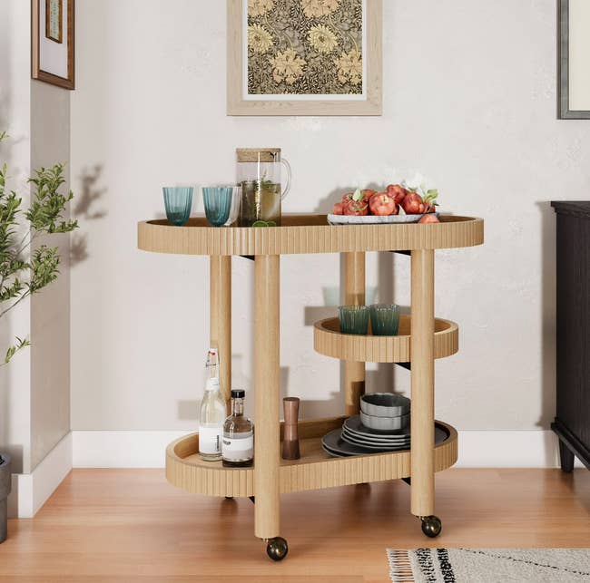 Wooden barroom cart with drinks, glasses, and fruit, acceptable successful a country with modern decor, cleanable for stylish location entertaining