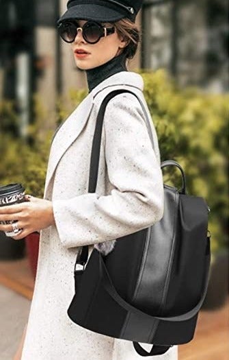 model wearing the black backpack