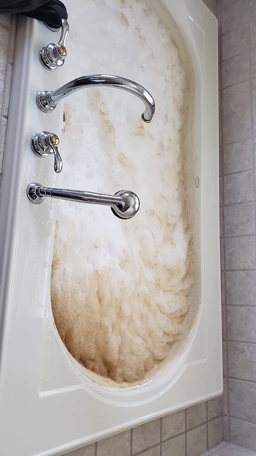 reviewer before photo showing a tub full of dirty foam while being cleaned