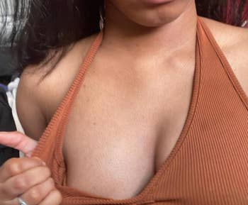 Person wearing a ribbed halter top, partially visible, with a textured fabric